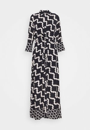 Robe longue noire et blanche à motif, avec col, manches longues, ceinture à la taille et bordure à motif géométrique contrasté aux poignets et à l’ourlet.