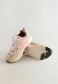 Sneakers with a pink, beige, and white color scheme; textured fabric and synthetic materials; leopard print accents; rubber outsole.