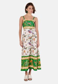 Abito maxi con un corpetto verde a fantasia e una gonna a stampa floreale; presenta spalline sottili, una vita cinchata e un orlo fluente.