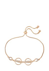 Bracciale regolabile in oro rosa con due charm a forma di pesce scheletro decorati con piccole cristalli trasparenti su sfondo bianco.