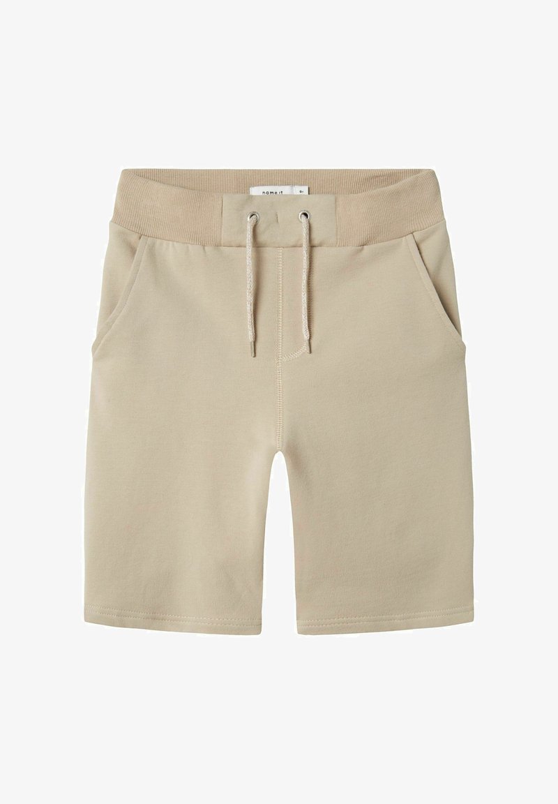 Beżowe bawełniane szorty z elastycznym pasem, zapięciem na sznurek i dwiema bocznymi kieszeniami. Gładka tekstura ze stębnowanymi brzegami.