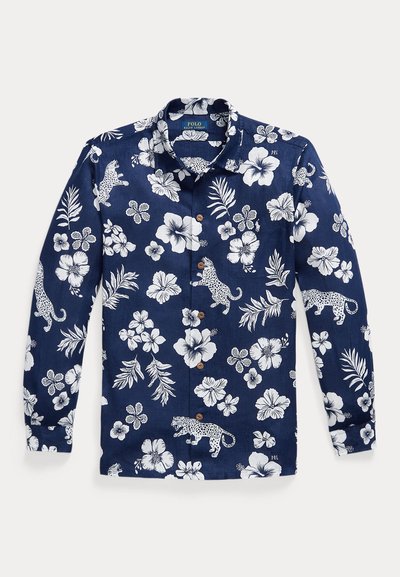 Μακρυμάνικο πουκάμισο σε ναυτικό μπλε με λευκά τροπικά λουλούδια, φύλλα και μοτίβα λεοπάρ, με μπροστινή τσέπη και καφέ κουμπιά.