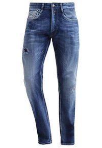 Blå denimjeans med slim fit, slitna detaljer, fem fickor och en urtvättad struktur med whiskering-effekt.