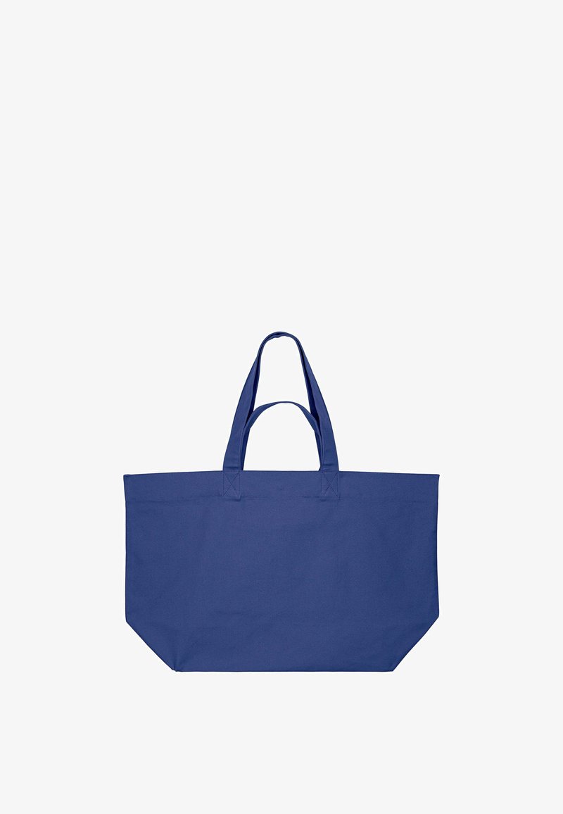 Grand sac cabas bleu marine avec deux paires de poignées, en tissu, sur fond blanc.