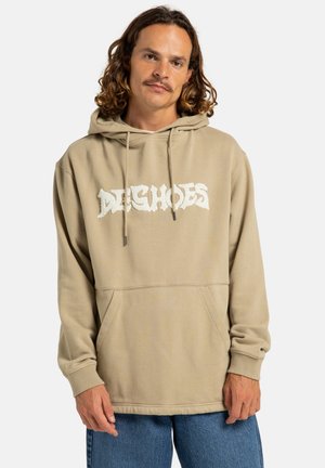 Beige hoodie with a front pocket and drawstring. Features white, textured "DEASHOES" logo. Long sleeves with ribbed cuffs. Soft fabric.