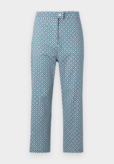 Pantalon slim avec motif géométrique de cercles bleu, blanc et noir, fermeture par bouton et zip, taille mi-haute.