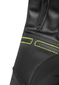 Dettaglio di un guanto in pelle nera con cuciture giallo neon, che mostra una superficie testurizzata e un design affusolato. Nessun motivo o hardware aggiuntivo.