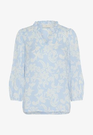 Világoskék blúz fehér virágmintával, fodros nyakkivágással és hosszú ujjal. Puha, könnyű anyag, laza szabással.