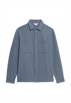 Hemd mit Knopfleiste aus weichem, hellblauem Stoff. Mit Kragen, zwei aufgesetzten Taschen und langen Ärmeln mit Knopfmanschetten. Glatte Textur, simples Design.