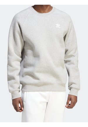 Sweatshirt en coton gris avec un col rond, des poignets et un ourlet côtelés. Présente un petit logo Adidas blanc sur la zone de la poitrine gauche.