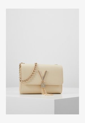 Beige textured handbag with a gold chain strap, featuring a prominent gold "V" logo and a decorative gold tassel accent.