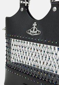 Black handbag featuring a top section of smooth leather and a netted design adorned with colorful, shiny beads and silver hardware accents.