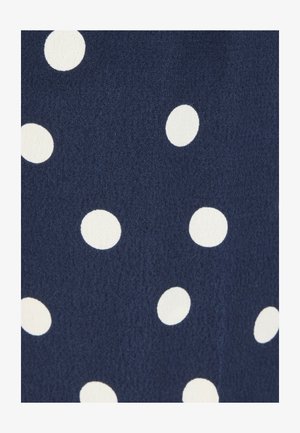 Navy blue fabric with scattered white polka dots of varying sizes and slightly textured surface.