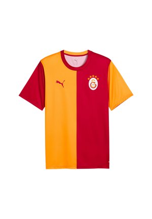 Koszulka piłkarska z krótkim rękawem, podzielona pionowo na żółtą lewą i czerwoną prawą stronę, z logo Puma i herbem klubu Galatasaray z pięcioma gwiazdkami.