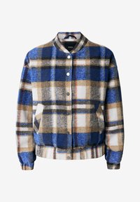 Veste boutonnée à carreaux bleus, bruns, blancs et noirs, poches latérales, col, poignets et ourlet côtelés, présentée sur un cintre.