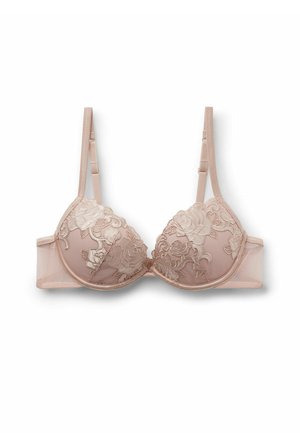 Soutien-gorge avec armatures en beige doux, recouvert de dentelle florale. Coupes rembourrées, bretelles ajustables et bandeau lisse au dos. Détail de motif floral texturé.