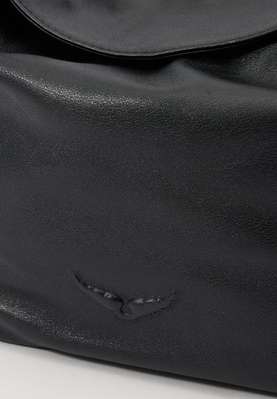 Black leather bag with a smooth texture and a flap closure. Features embossed wings design as a notable detail.