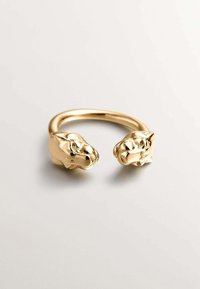 Anillo de tono dorado que presenta dos cabezas de animales estilizadas como terminales. El diseño tiene un acabado suave y pulido con rasgos faciales detallados.