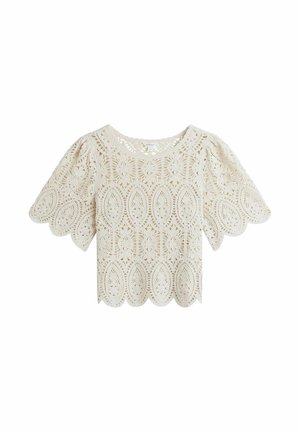 Kremfarvet bluse med korte ærmer i blonder med bølget kant og blomsterformede geometriske hulmønstre, med rund halsudskæring og puffede ærmer.