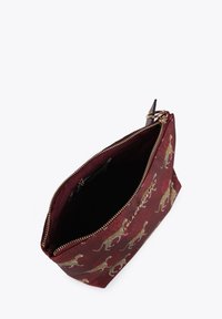 Maroon fabric bag with gold leopard print, zip closure, and gold hardware. Interior appears black and smooth, with a spacious opening.