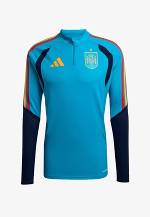 Blue athletic long-sleeve jersey with a high collar, featuring red and yellow stripes, dark blue sleeves, and a Spain national emblem.