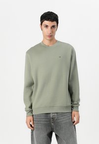 Lichtgroene sweatshirt van een katoenmix, met een ronde hals, geribde manchetten en een klein logo op de borst. Casual ontwerp, ontspannen pasvorm.