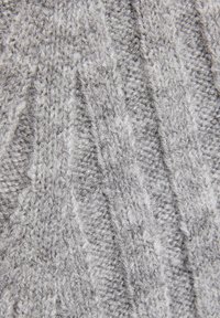 Šedá pletená tkanina s texturovaným vzorem zahrnujícím diagonální žebrování a malé vyvýšené stehů. Měkká, střední tloušťky.