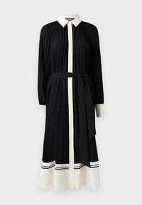 Long-sleeved, pleated black dress with a white collar and buttons, featuring a belted waist and contrasting white hem with branding.