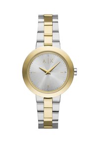 Metalinis laikrodis su sidabriniu tekstūruotu ciferblatu ir aukso akcentais. Savybė – dviejų spalvų sidabro ir aukso metalinė apyrankė. Paženklintas raidėmis "A|X."