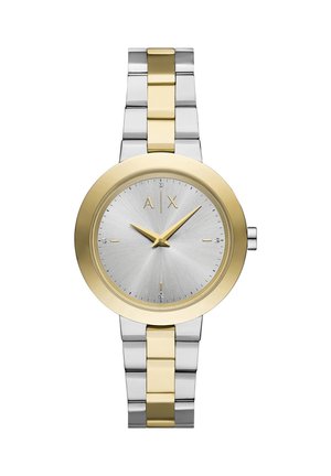 Metalni sat s srebrnim teksturiranim brojčanikom i zlatnim akcentima. Ima dvobojnu metalnu narukvicu u srebrnoj i zlatnoj boji. Oznaka s natpisom "A|X."