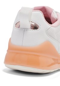 White sneaker with a textured surface, light pink accents, and a translucent orange sole. Features a pull tab and a metallic detail.