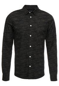 Camicia nera a maniche lunghe con motivo testurizzato, caratterizzata da una chiusura frontale con bottoni, colletto a punta e bottoni bianchi. Tessuto liscio con sottili strisce.