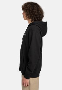 Black hoodie made from soft cotton, featuring a kangaroo pocket, adjustable drawstring hood, and text design on the front.