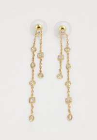 Boucles d'oreilles pendantes dorées avec un design en chaîne alternant des pierres claires rectangulaires et ovales, maintenues par des supports transparents.