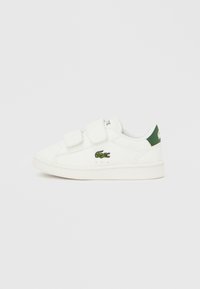 Λευκά αθλητικά παπούτσια με βέλκρο, με πράσινη απόχρωση και κεντητό λογότυπο κροκόδειλου. Διαθέτουν εξωτερικό από λείο δέρμα και λαστιχένια σόλα.