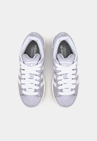Gray suede sneakers with white laces and three white stripes. Features a padded collar and textured rubber sole. Adidas logo on tongue.