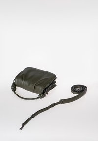 Olijfgroene leren crossbody tas met een zachte, gestructureerde oppervlakte, geknoopte accenten op de schouderriem en een dunne verstelbare schouderriem.