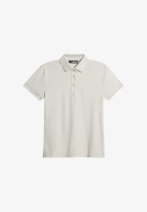 Koszulka polo w jasnym beżu, wykonana z gładkiego materiału, z kołnierzykiem, krótkimi rękawami, pięcioma guzikami oraz haftowanym logo marki na rękawie.