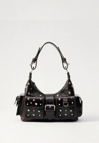 Mustast nahast käekott naelutatud detailidega, ümar kuju, kaks eesmist taskut ja pandlaga kinnis. Omab lühikest õlarihma.