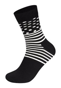 Chaussette noir et blanc présentant une combinaison de motifs rayés et de pois, avec un talon renforcé et un bord côtelé.