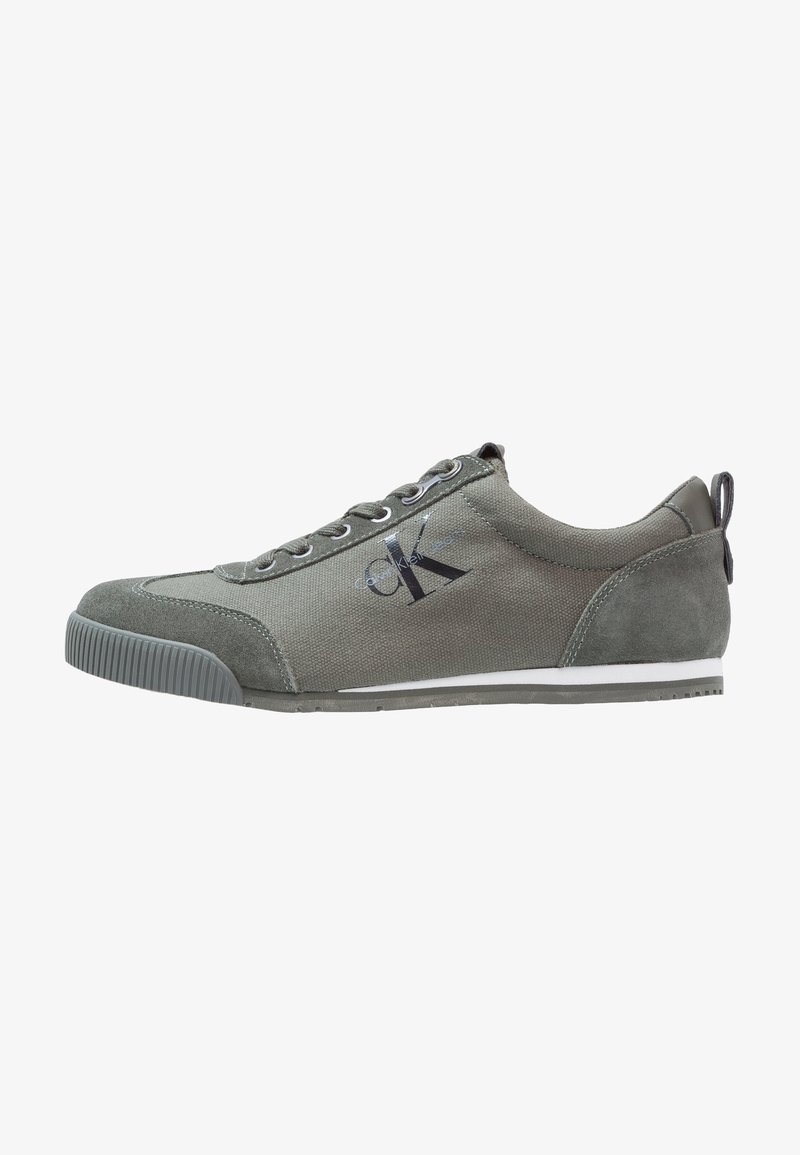 Gray casual sneakers with a mix of fabric and suede, featuring a white stripe, lace-up design, and logo detail on the side.