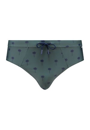 Herren-Schwimmbriefs in Grün mit einem Palmenmuster. Mit einem kontrastierenden Kordelzugbund in Marineblau. Hergestellt aus glattem, elastischem Stoff.