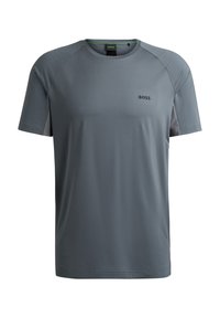 T-shirt gris à manches courtes en tissu lisse avec un col rond. Présente des panneaux latéraux en mesh contrastants et un logo noir à l'avant.