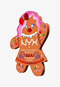 Paleta do makijażu w kształcie piernikowego ludzika w brązowym kolorze z różowymi włosami, czerwonymi ustami i ozdobnymi akcentami, takimi jak kolorowe kropki i zawijasy. Widoczne logo marki.