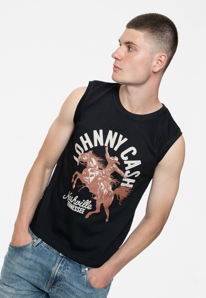 Black sleeveless cotton shirt featuring a graphic print of a cowboy on a horse with the text "Johnny Cash" and "Nashville Tennessee" in cream and brown.