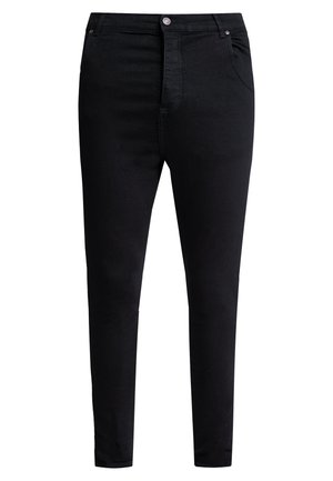 Sorte slim-fit jeans med knapper og lynlås foran, med forlommer og bæltestropper, vist på en hvid baggrund.