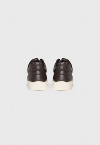 Brown leather sneakers with a textured finish, featuring a white rubber sole and contrasting stitching. No visible branding or embellishments.