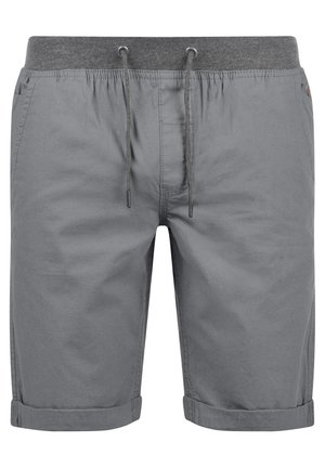 Sive bombažne kratke hlače z elastičnim pasom na vrvico, zavihanimi manšetami in minimalnimi šivi, ki imajo gladko teksturo in preprost dizajn.