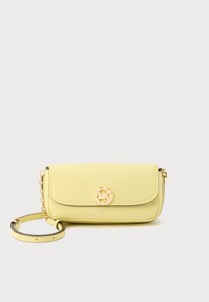 Yellow leather crossbody bag with gold chain strap and round gold logo clasp on front flap, set against white background.