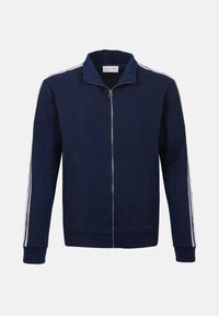 Veste zippée bleu marine en tissu doux avec un col haut, ornée de rayures blanches le long des manches et de poignet côtelé.